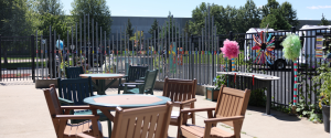 A photo of tables and chairs on the patio at the Apple Valley sensory garden