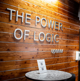 A photo of the outside wall of the Uponor training center. Words on the wall read: "The power of logic"