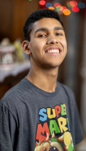 Photo of Wyatt wearing a Super Mario shirt and smiling